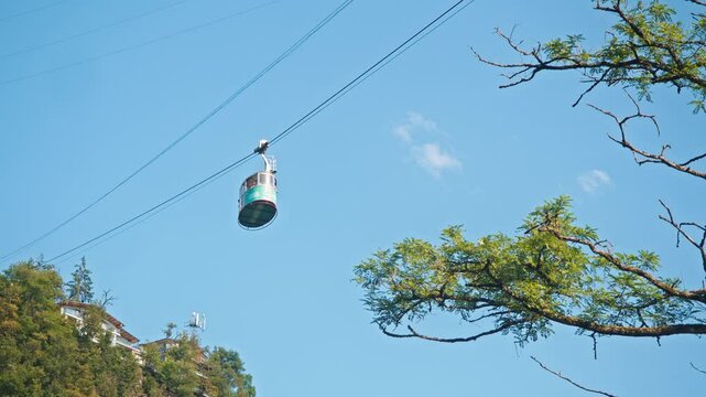 Vintage funicular cabin, powered by a cable car system, descends in the summer months, transporting tourists from their accommodation located at the summit of the mountain.