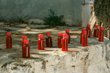 St. John's Wort oil in red bottles. St. John's Wort has been consumed for thousands of years as a plant believed to have healing properties and has many uses in traditional medicine.