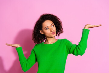 Photo of charming interested woman wear green stylish clothes demonstrate empty space hmm isolated...