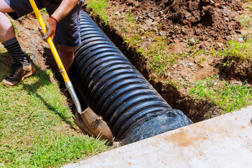 In course of construction, drainage black pipe is installed in trench