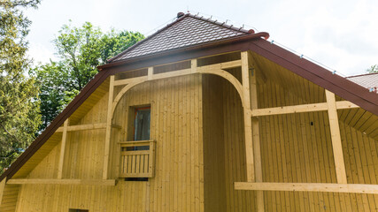 Modern Wooden House with Large Windows and Terracotta Roof