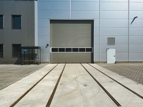 Entrance gates to a modern warehouse. Docks for trucks.  Tin white doors 