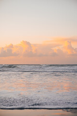 sunset on the beach and waves hitting the sand