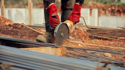 construction worker cutting iron