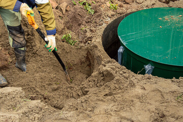 Installation of a biological wastewater treatment system. Filling the septic tank with sand to...