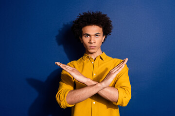 Portrait of nice young man crossed arms wear yellow shirt isolated on dark blue color background