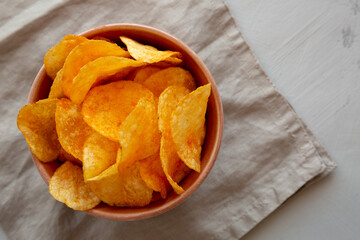 Homemade Flavored Cheese Potato Chips in a Bowl, top view.