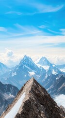 Fototapeta premium Snowy mountain peaks under a clear blue sky with sharp ridges and dramatic landscapes. The scene captures the beauty of rugged mountains and serene skies.