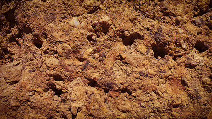 A rugged natural texture featuring earthy tones of brown and orange, with stone elements, ideal for natural-themed backgrounds, wallpapers, and creative designs