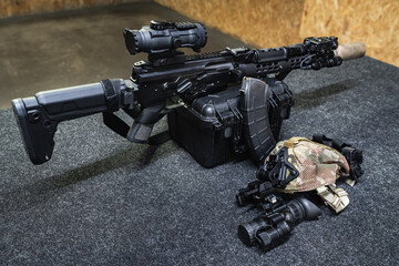 Tactical rifle shooting at a shooting range, AK series rifle with a silencer, laser sight, flashlight and night vision device.