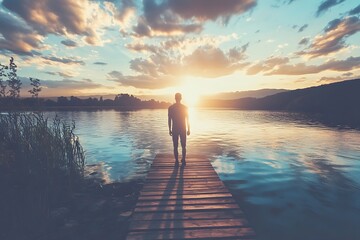 Fototapeta premium Silhouette of Man Standing on Dock at Sunset Over Water
