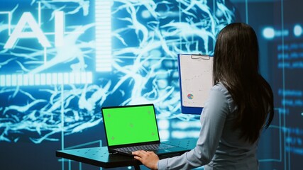 IT specialist using green screen laptop and AI technology for business data analysis in high tech...