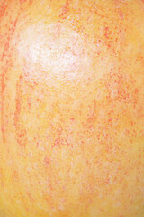 Apple as a background. Macro photo of the texture of a light red and yellow apple