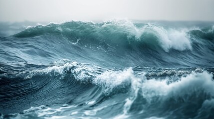 Close-up of rough sea waves crashing against surface. Turbulent water, white foam, and blue ocean background. Stormy weather creates powerful waves, empty beach, no people in sight.