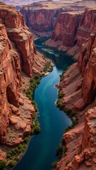 Ancient red canyon with winding blue river below