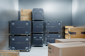 Storage of concert equipment in a warehouse. Boxes on wheels.
