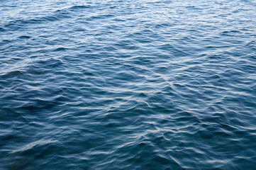 Blue abstract ocean seascape. Surface of the sea. Water waves top view.