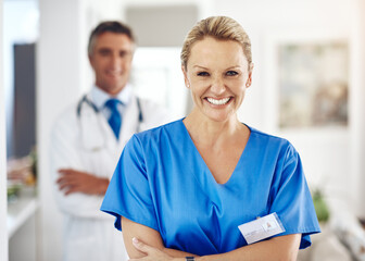 Mature woman, doctor and staff portrait with hospital, healthcare and clinic professional with confidence. Cardiology, stethoscope and wellness worker with happy and smile at ICU care job as surgeon