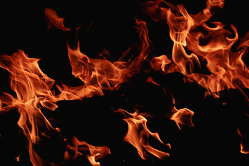 Fire over black background. Fire sparks background. Abstract blaze flames background. Burning fire....
