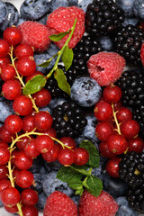Mix of wild forest berry fruits. Blueberry, raspberry, blackberry. Healthy fresh berries background. Berries as background. Summer berries pattern. © Korneliia
