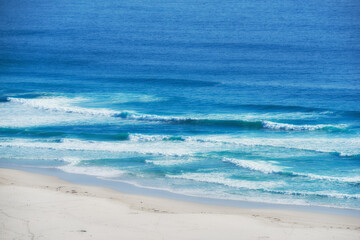 Landscape, beach and coast with sand, waves and peace for tropical holiday, nature and travel. Sea, water and ocean outdoor in summer sunshine for luxury vacation, tourism and adventure in Ibiza