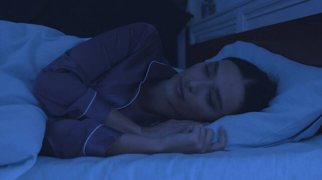 Sleep disorder. Young girl tossing and turning in bed, can't sleep