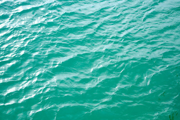 Water view. Sea water background. Green blue ocean water texture background. Sea water and ripples. Ocean background.
