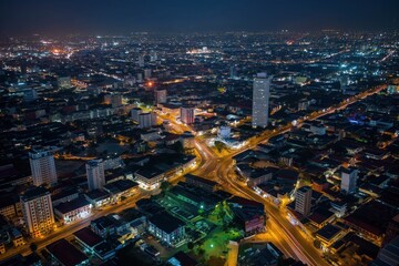 Obraz premium Aerial night shot of Accra city, Ghana capital. Cityscape features old buildings, modern architecture, railway bridge, streets, roads, people. Urban landscape with central business district, town,