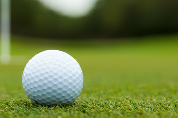 Obraz premium Golf ball on a course, grass background. Golfing and sports equipment concept.