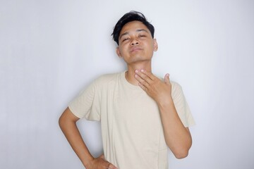 portrait of a handsome Indonesian man posing randomly wearing a Cream shirt on a white background isolated