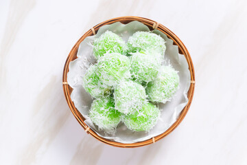 klepon or onde-onde made from glutinous rice flour and filled with brown sugar covered with grated coconut. Perfect for recipe, article, catalogue, commercial, or any cooking content.