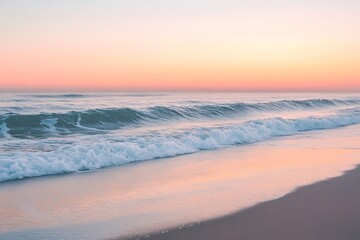 Peaceful ocean waves crashing on sandy beach during a colorful sunrise or sunset.
