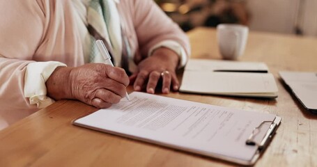 Senior, hands and writing on documents in home for life insurance policy, legal contract and retirement plan. Clipboard, person and paperwork for title deed, application form and asset management