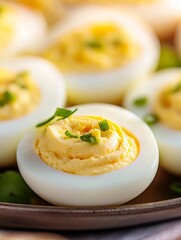 A platter of deviled eggs on an outdoor table ready for a party. 