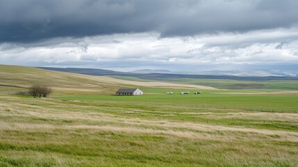 A serene landscape featuring a lone building amidst rolling hills and cloudy skies.