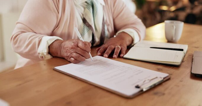 Senior, hands and writing on paperwork in home for life insurance policy, legal contract and retirement plan. Clipboard, person and documents for title deed, application form and asset management
