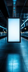 Illuminated blank advertisement panel in a modern train station.