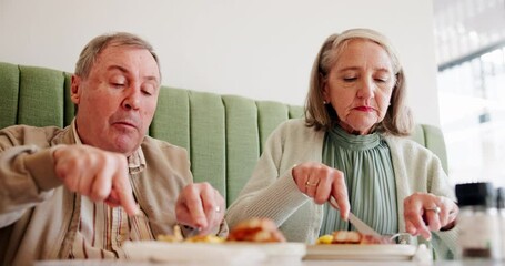 Elderly couple, eating and breakfast in restaurant for love, relationship and morning with partner on weekend. People, hungry and food in cafe for marriage, brunch and bonding with relax on date