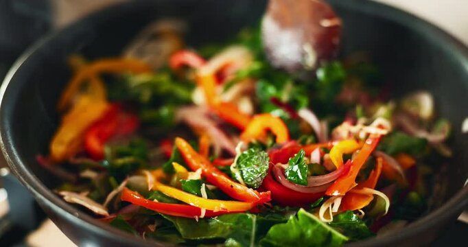 Closeup, spoon and cooking vegetables in house, eating and health with nutrition, flavor and stir fry. Frying, pan and person in kitchen for healthy breakfast, meal prep or food with diet in morning