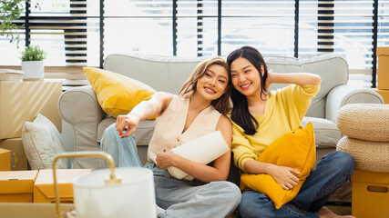 Two teenage girls are happily moving into a new house together and moving their belongings into their new home.