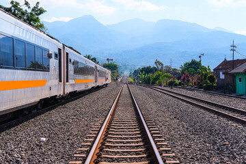 Fototapeta premium railway in the countryside, railroad tracks in the countryside, railway in Indonesia, train and railway, railway in the mountains, railway tracks, railway in the village, travel by train in Indonesia