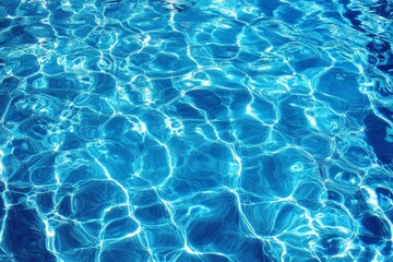 Abstract blue water surface with ripples and light reflections.