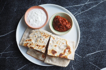 Indulgent and Flavorful Flatbreads Served with Variety of Dips on an Elegant Plate
