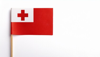 Obraz premium 小さな紙のトンガ王国の国旗（small paper Tonga flag） 