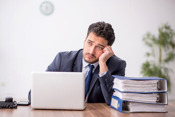 Young male employee working in the office