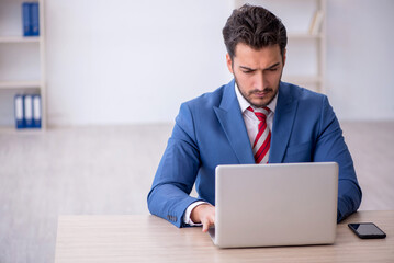 Young male employee working in the office