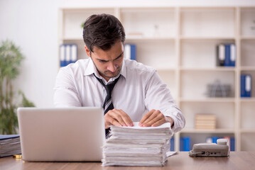 Young male employee working in the office