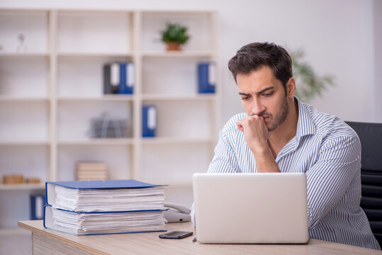 Young male employee working in the office