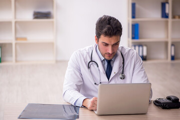 Young male doctor in telemedicine concept