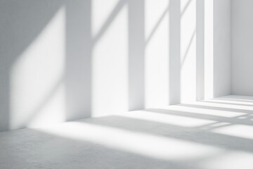 Fototapeta premium Minimalist white interior with sun rays and shadows falling on a white floor.